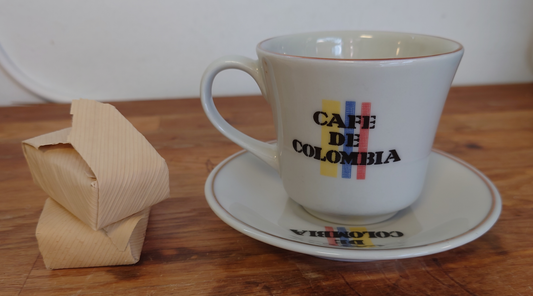 Traditional cup and saucer of the Federación nacional de cafeteros and Corona. Two delicious "bocadillos" representing the sweetness of our culture and coffee